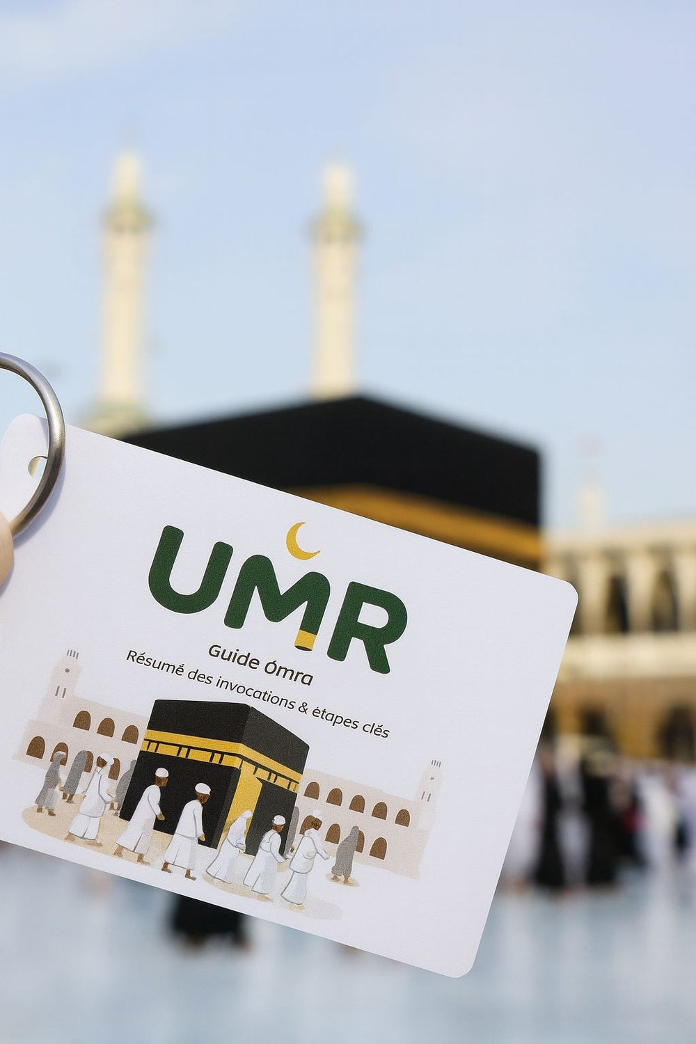 Le Mini-Guide Omra UMR tenu devant la Kaaba